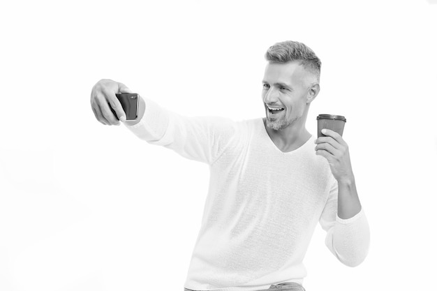 Good mood Enjoying his coffee Sharing good news Mobile communication Drink it on the go Coffee take away Mature man hold paper coffee cup stand white background Delicious fresh coffee concept