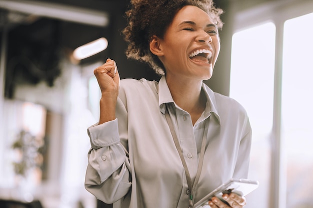 Good mood. Pretty young woman looking excited and happy