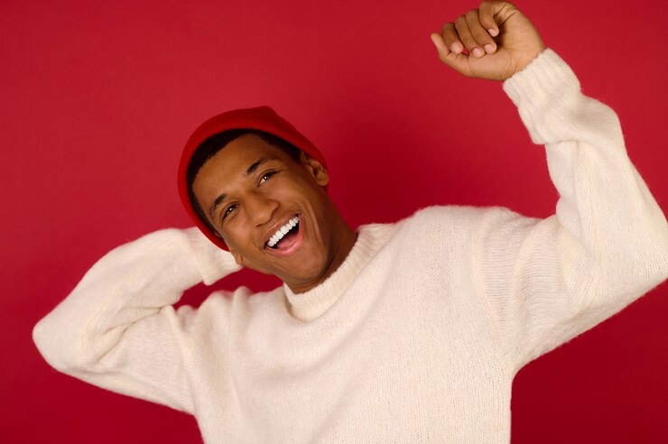 Good mood. Young dark-skinned man in santa hat smiling