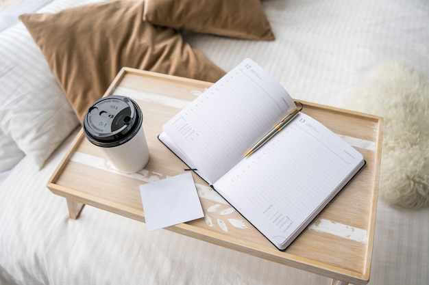 Good mornind. cup of coffee in bed. Close up. In beige interior. mock up card. High quality photo