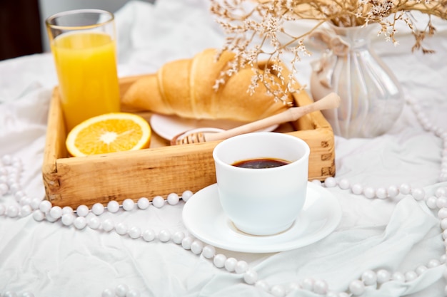 Good morning. Continental breakfast on white bed sheets.