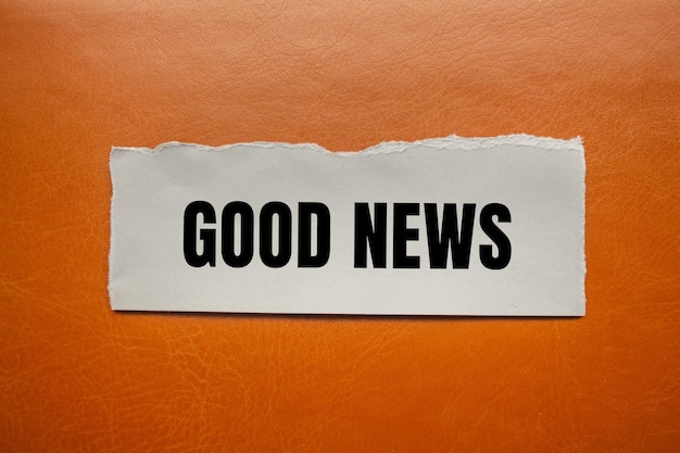 good news message written on ripped torn paper piece with brown background conceptual good news symbol copy space