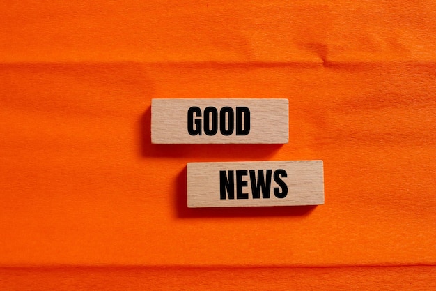 good news message written on wooden blocks with orange background conceptual good news symbol copy space