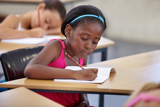 Good study habits start young A young girl in a classroom concentrating on her test