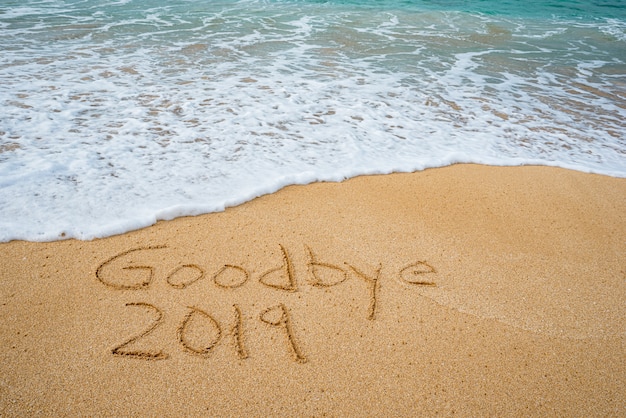 Goodbye 2019 written in the sand