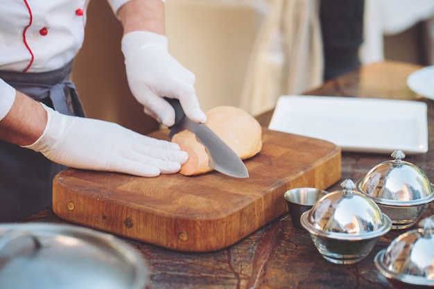 Photo goose liver on a wooden board in the restaurant before cooking.