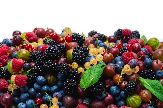 Gooseberries, blueberries, mulberry, raspberries, white and red currants isolated on white background.