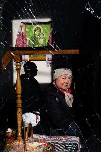 GORENKA KYIV REG UKRAINE Apr 24 2022 People attend an Orthodox Easter church service and orthodox priest sprays holy water on believers and baskets in Gorenka Kyiv region Ukraine