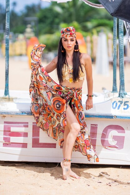 Photo gorgeous bikini girl on a beach with gypsy style dress