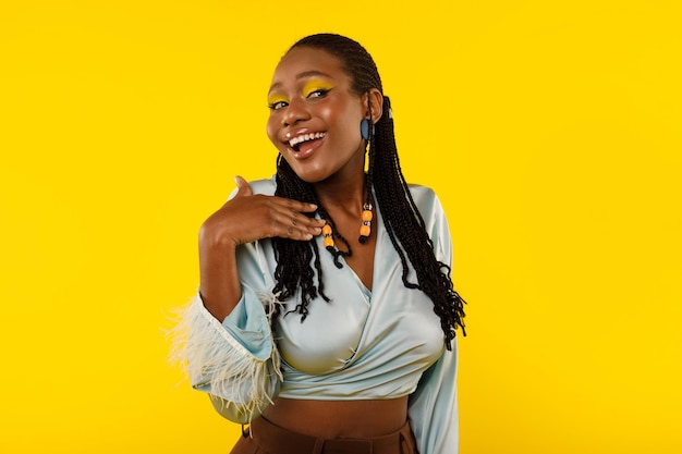 Gorgeous Black Woman With Bright Makeup Posing On Yellow Background