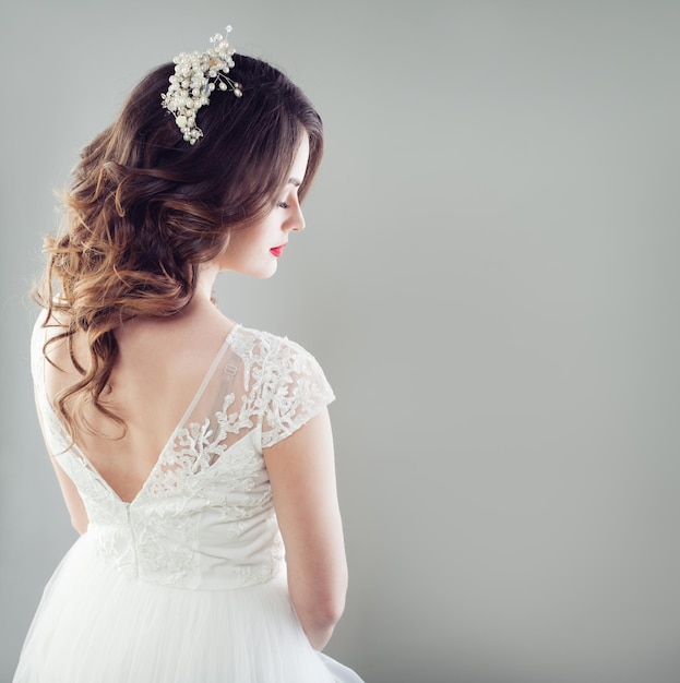 Splendida sposa donna con capelli da sposa trucco hairdecor e abito da sposa bianco bella femmina indietro