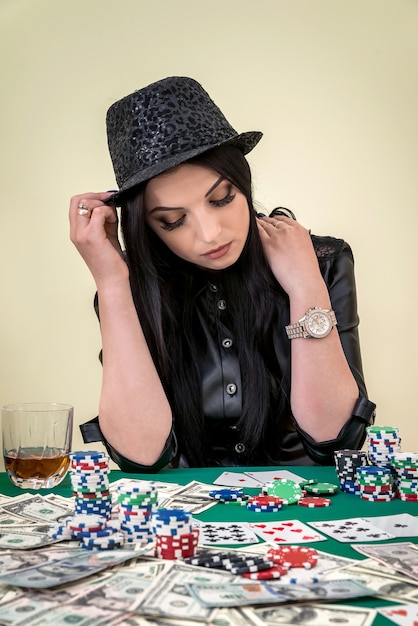 Gorgeous brunette woman posing in casino, gambling