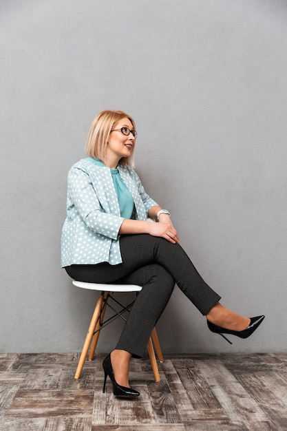 Gorgeous business woman sitting isolated