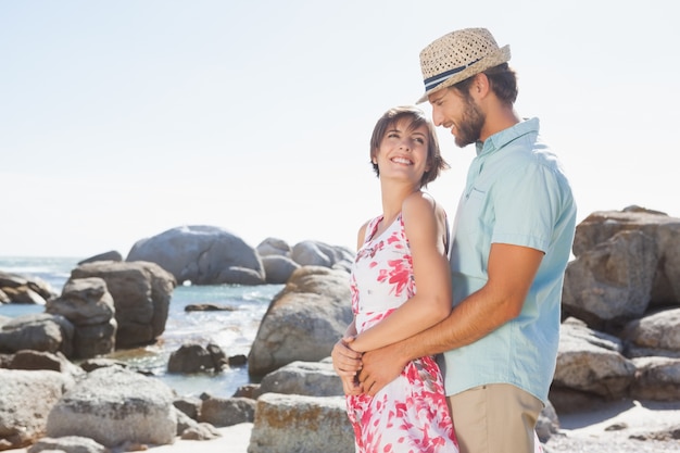 Gorgeous couple embracing by the coast