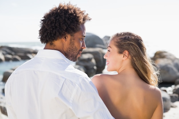 Gorgeous couple embracing by the coast