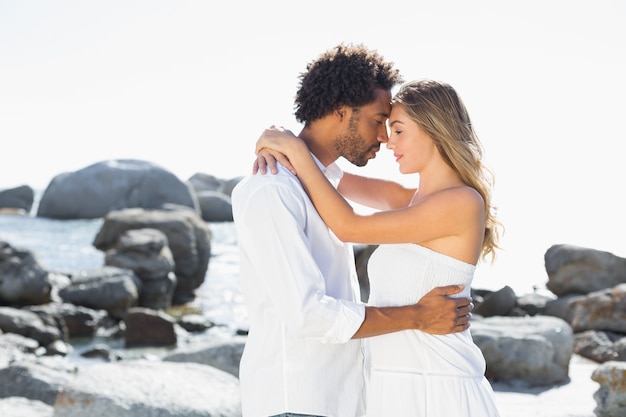 Gorgeous couple embracing at the coast