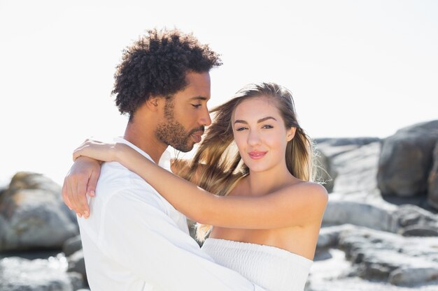 Gorgeous couple embracing at the coast