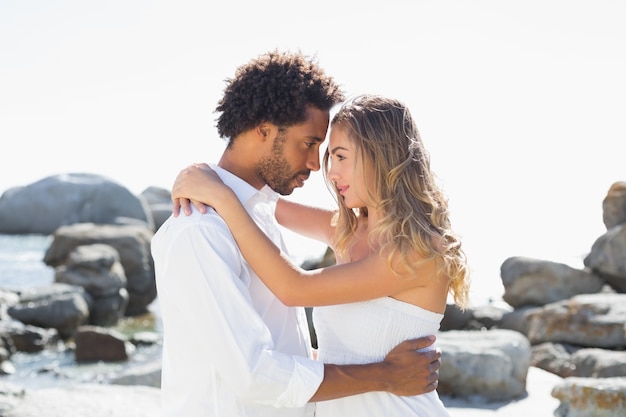 Gorgeous couple embracing at the coast