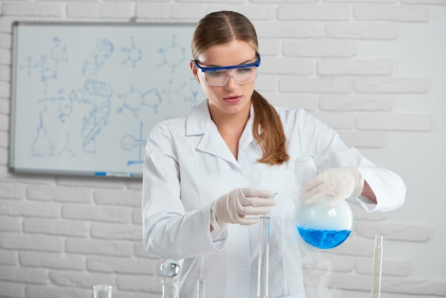 Gorgeous female chemist working at the lab testing samples