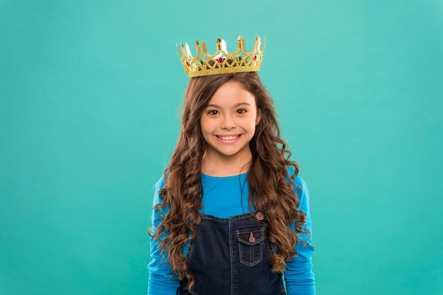 Gorgeous hair award Kid wear golden crown symbol of princess Girl cute baby wear crown blue background Princess concept Every girl dreaming to be princess Little princess Curly hairstyle