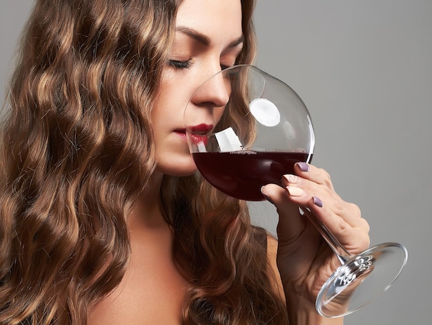 Gorgeous lady with glass of red wine