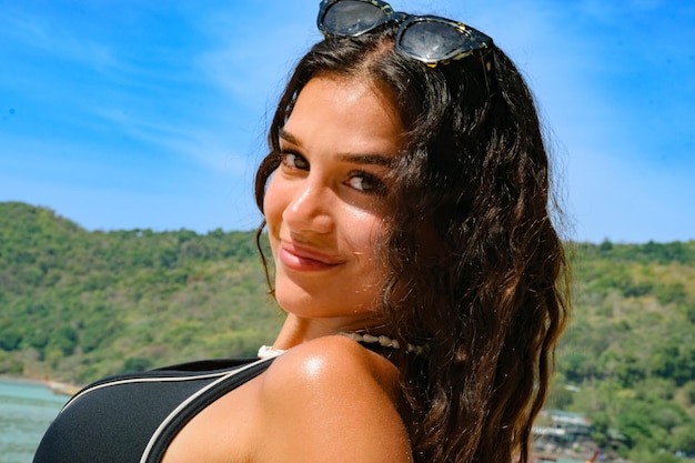 Gorgeous Lebanese young woman enjoying on beach and posing with sunglasses