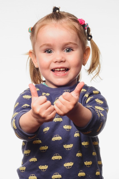 Gorgeous little girl shows her whole class with a thumb