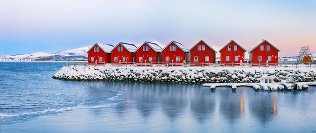 Gorgeous scenery wit traditional red wooden houses on the shore of offersoystraumen fjord popular travel destination on lofotens location vestvagoy island lofoten norway europe