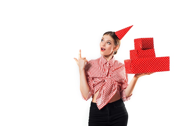 Gorgeous slim young woman wearing in a striped red with red gift boxes