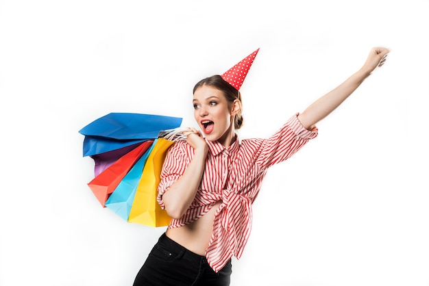 Gorgeous slim young woman wearing in a striped red with red gift boxes