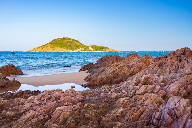 Gorgeous tropical beach turquoise transparent water unique rock boulders, Cam Ranh Nha Trang Vietnam south east coast travel destination, desert beach no people clear blue sky