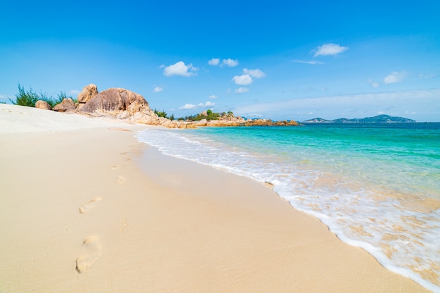 Gorgeous tropical beach turquoise transparent water unique rock boulders Vietnam