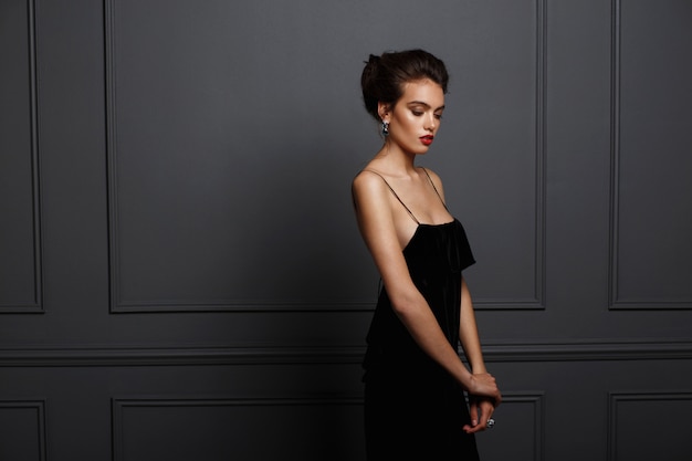 Gorgeous woman in a black dress with bare shoulders