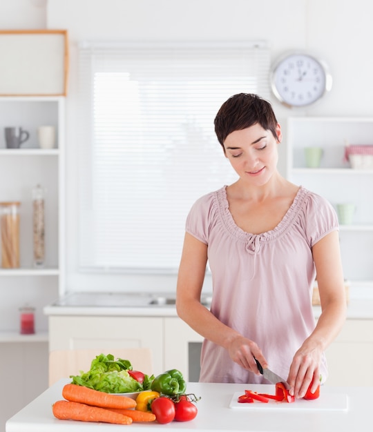 Gorgeous woman cutting vegetables