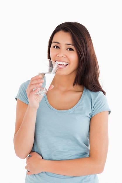 Gorgeous woman drinking a glass of water