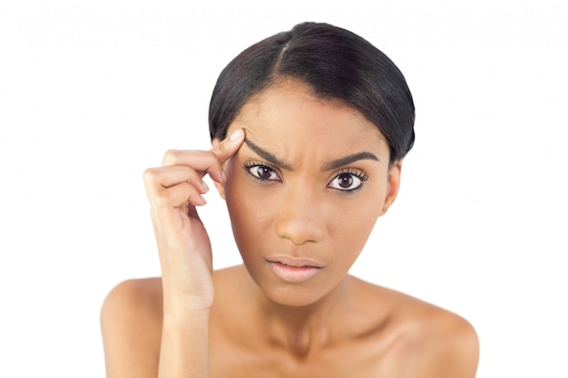 Gorgeous woman examining her eyebrow