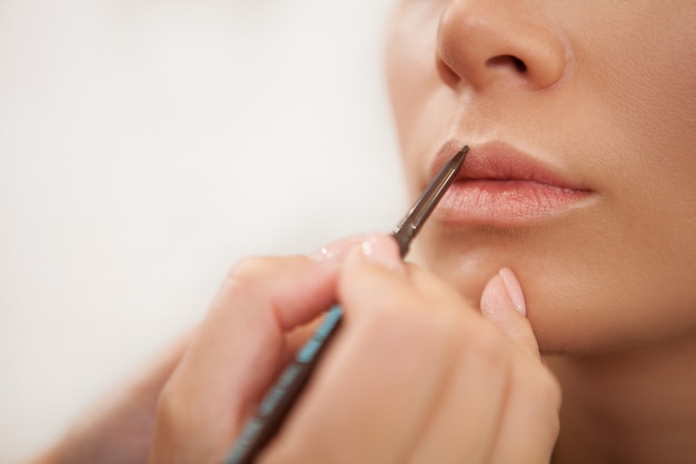 Gorgeous woman getting professional makeup