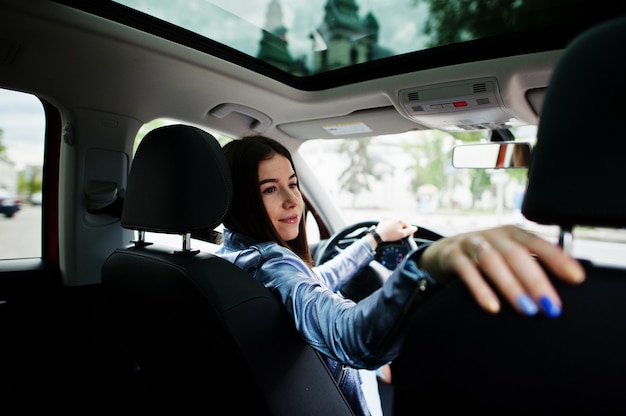 Gorgeous woman sitting inside car interior