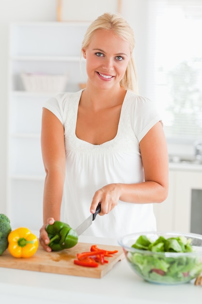 Gorgeous woman slicing pepper