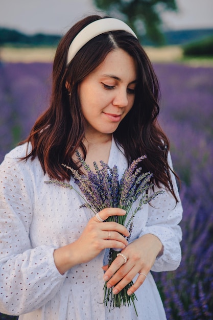 Gorgeous woman in white dress at lavender field sunset time