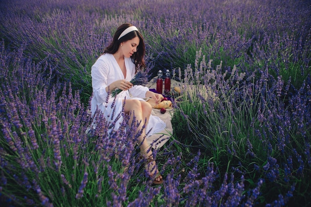 Gorgeous woman in white dress at lavender field