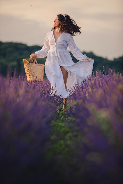 Gorgeous woman in white dress at lavender field