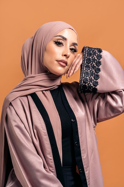 Gorgeus muslim woman looking at camera posing in studio. She's serious.