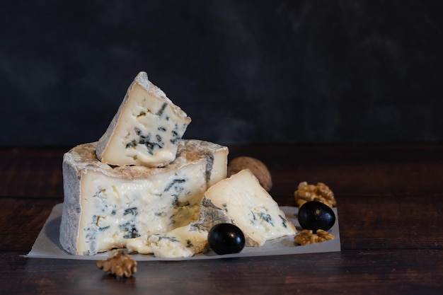 Gorgonzola blue mold cheese with grapes and nuts. Handmade.