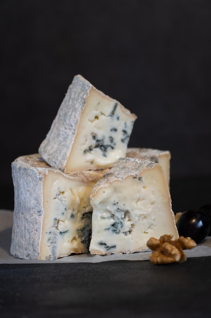 Gorgonzola blue mold cheese with grapes and nuts. Handmade.