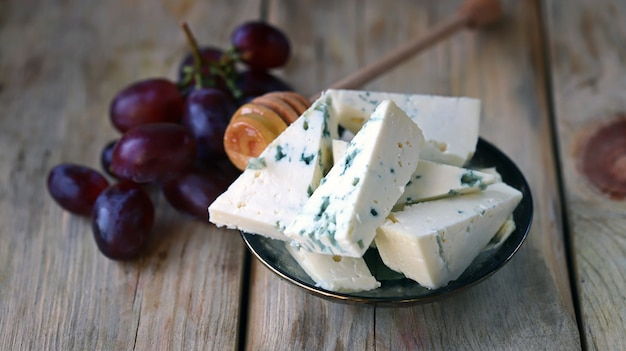 Gorgonzola cheese with honey and grapes Cheese plate Keto snack