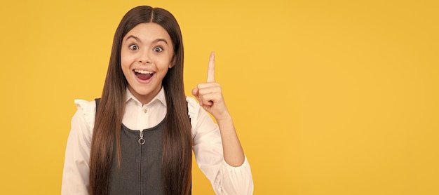 Got idea Happy kid keep finger up yellow background Idea Eureka Inspiration Think big Child face horizontal poster teenager girl isolated portrait banner with copy space