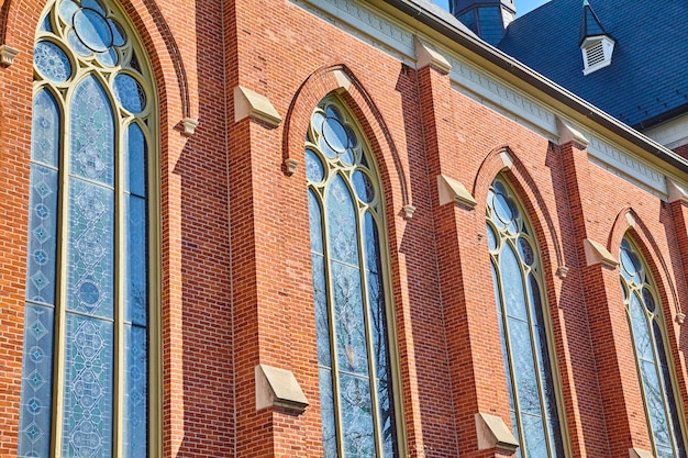 Photo gothic church architecture with stained glass in sunlight low angle view