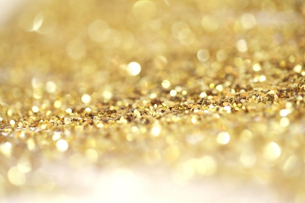 Goud (brons) glitter glans stippen confetti. Abstract licht knipperen sparkle defocus achtergrondkleur.