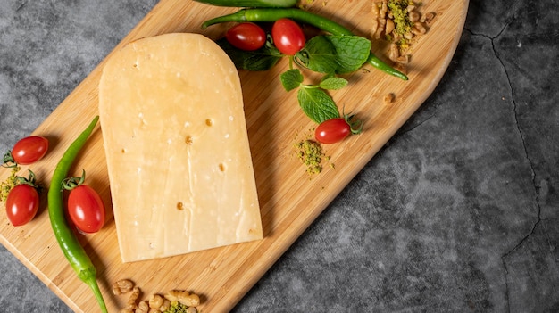 Gouda cheese Piece of gouda cheese on wooden cutting board Cheese collection Ripe hard cheese made from cows milk in the Netherlands Top view Empty space for text Copy space